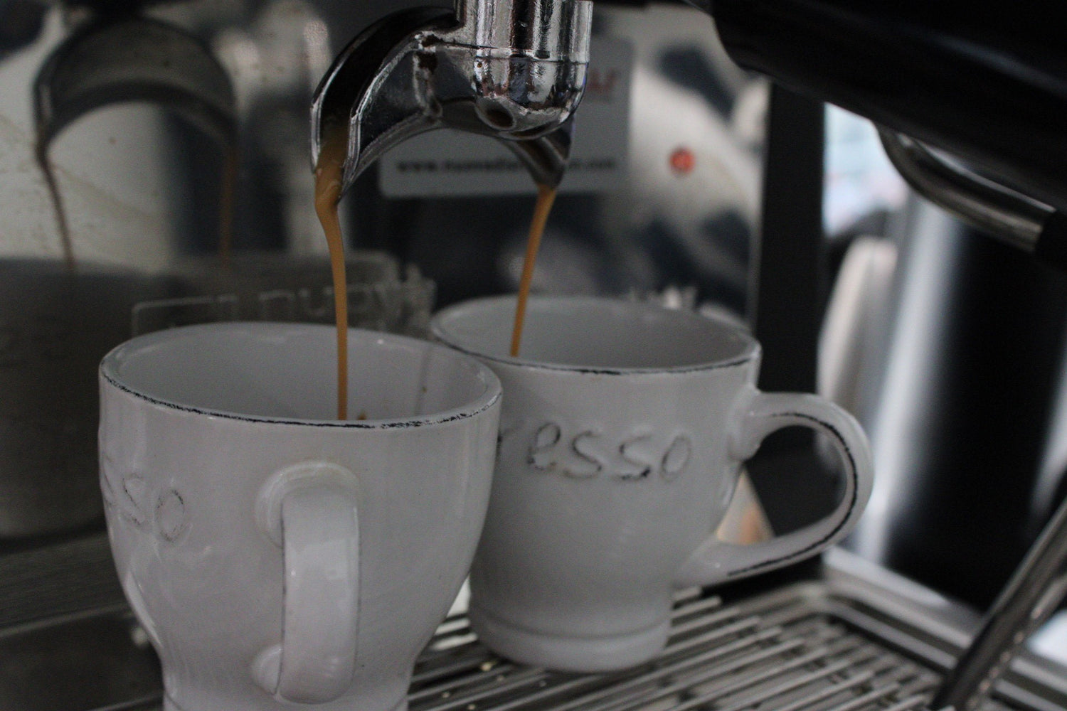 espresso double shot being pulled into two glasses
